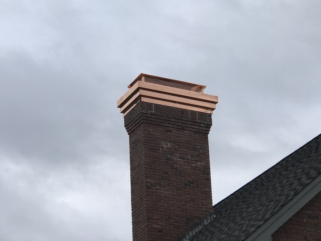 Chimney with a copper chimney cap